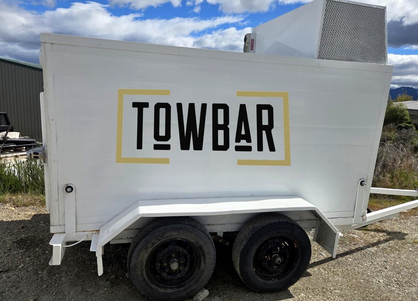 White Towbar chiller trailer with the logo on the side